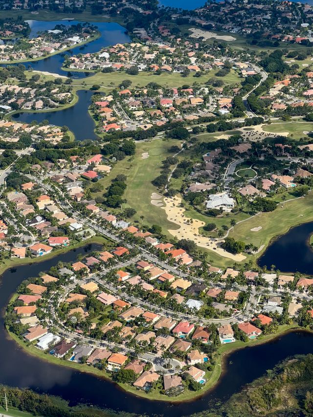 Beautiful aerial view of a residential neighborhood with lakes and greenery in Florida.